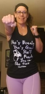 photo of the site owner with a tank top that reads "she's beauty she's grace she'll punch you in the face" 
