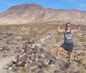 photo of the site owner in the desert holding arms up in a muscle pose